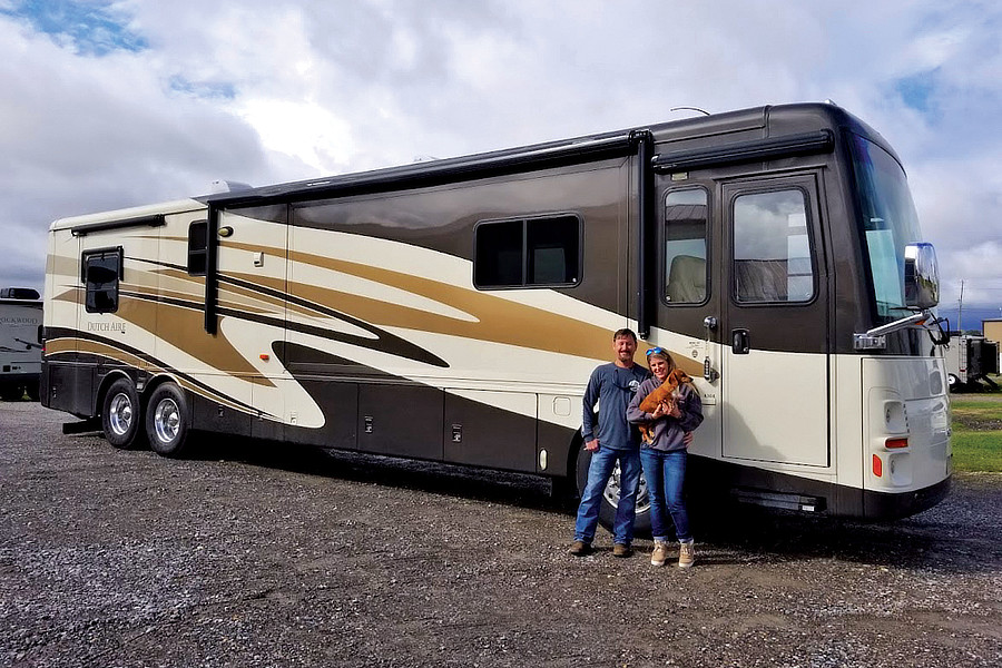 Couple in front of Class A motorhome